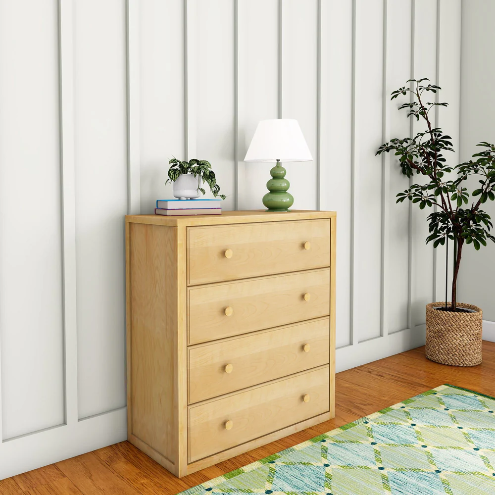 Maxtrix 4 Drawer Dresser Natural Room Scene Angle View Maxtrix 4 Drawer Dresser in Natural - angled room view on hardwood flooring with a patterned rug, lamp and plant styling
