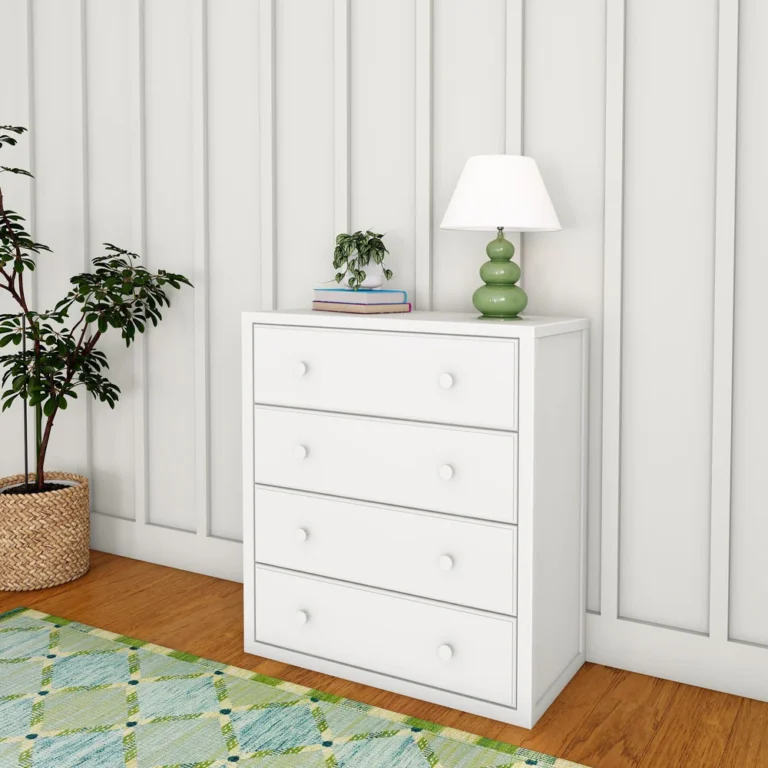 Maxtrix 4 Drawer Dresser White Room Scene Maxtrix 4 Drawer Dresser in White - angled view in a bedroom with round wood knobs, styled with a lamp, plant and books on top