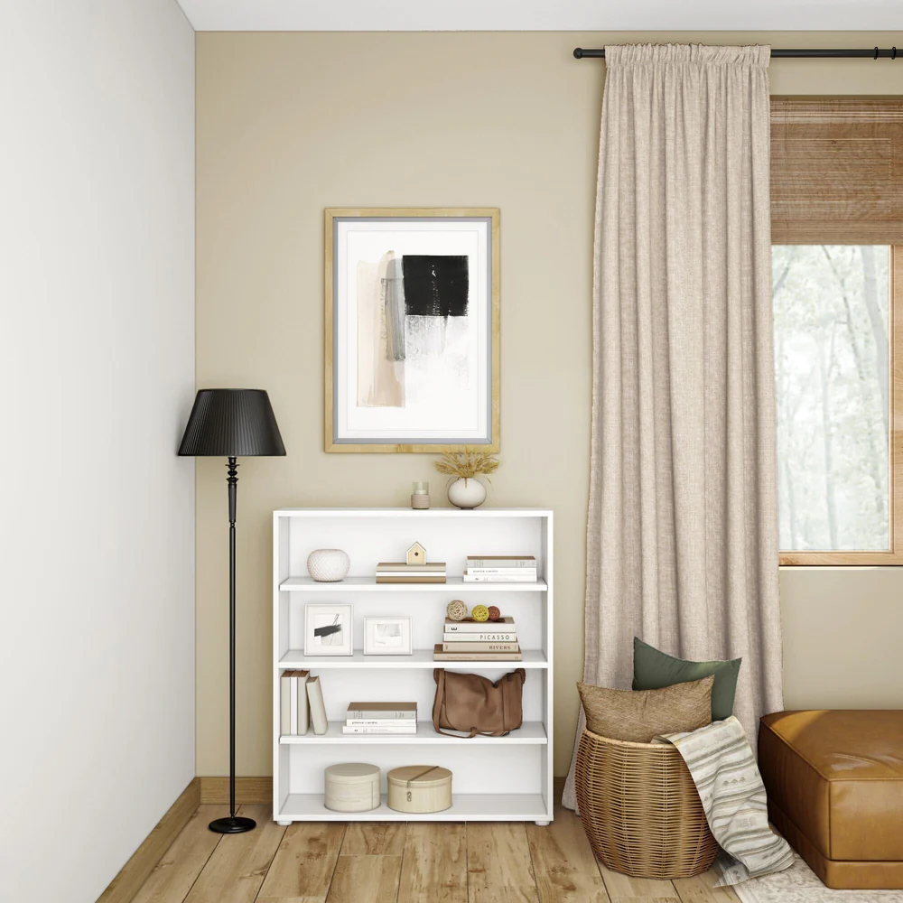 Maxtrix 4 Shelf Bookcase in White - styled in a living room corner with books, framed photos and decor on the shelves beside a window with curtains