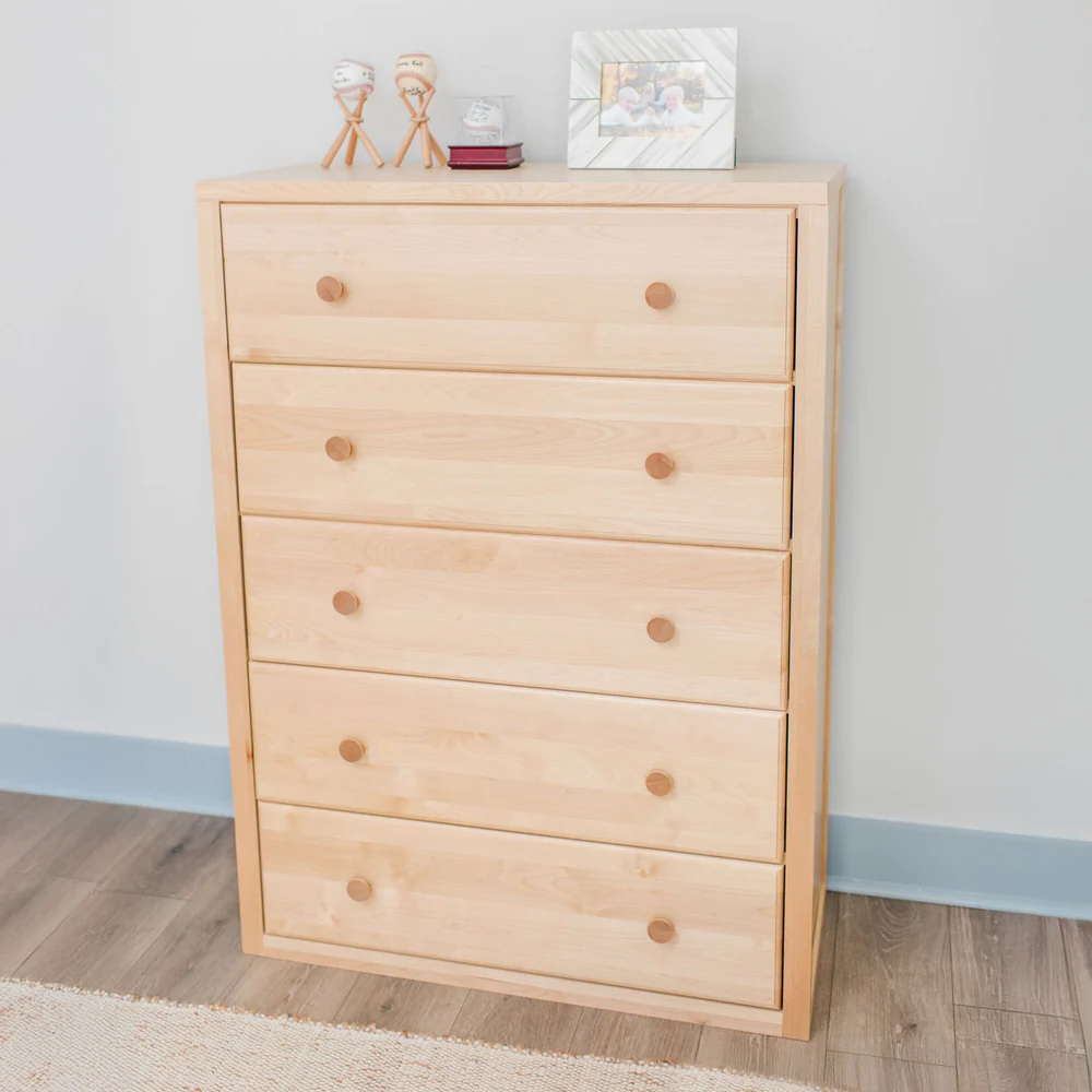 Maxtrix 5 Drawer Dresser Natural Room Scene Maxtrix 5 Drawer Dresser in Natural - photographed in a bedroom with keepsakes and a framed photo displayed on top