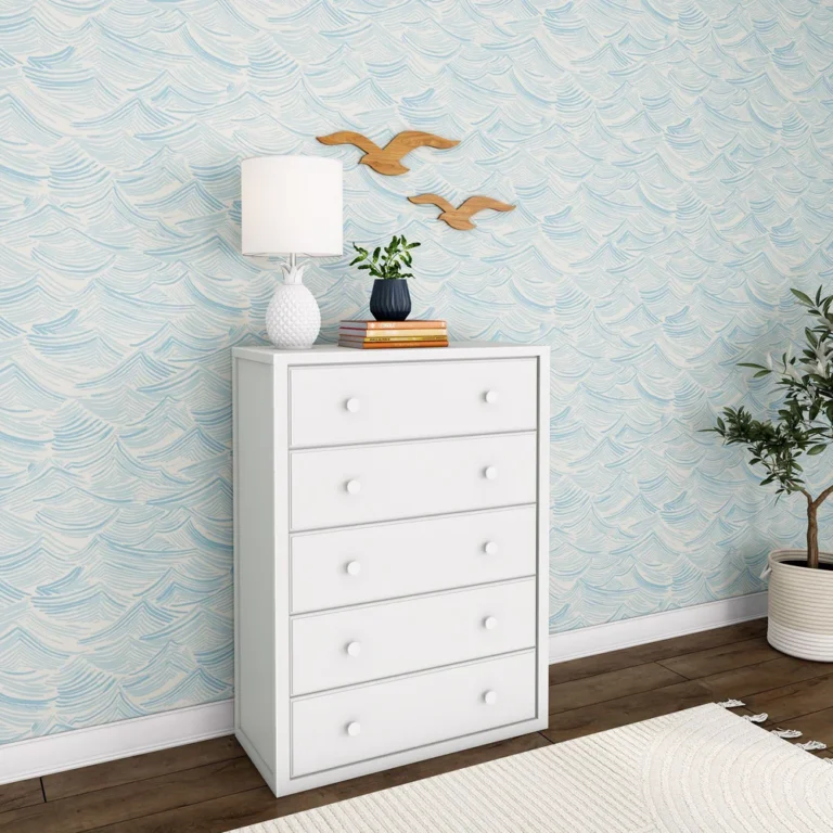Maxtrix 5 Drawer Dresser White Room Scene Angle View Maxtrix 5 Drawer Dresser in White - angled room view showing the dresser side panel and five spacious drawers beside a potted tree and area rug