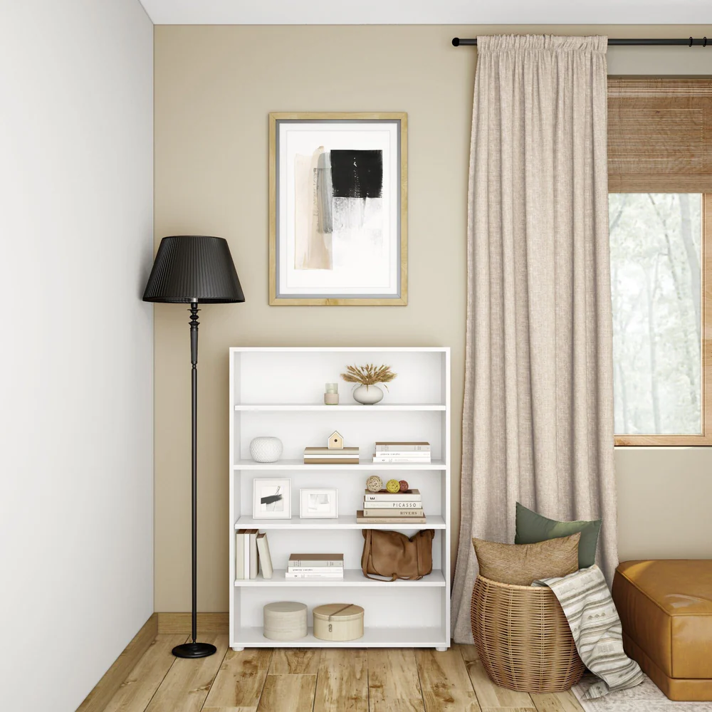 Maxtrix 5 Shelf Bookcase in white - styled in a living room corner with books, framed prints and baskets, beside a floor lamp and curtained window