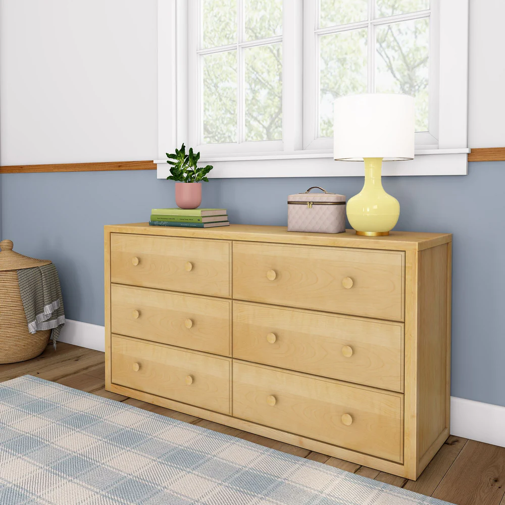 Maxtrix 6 Drawer Dresser - angled view in a bedroom, styled with a lamp, potted plant, and books on top