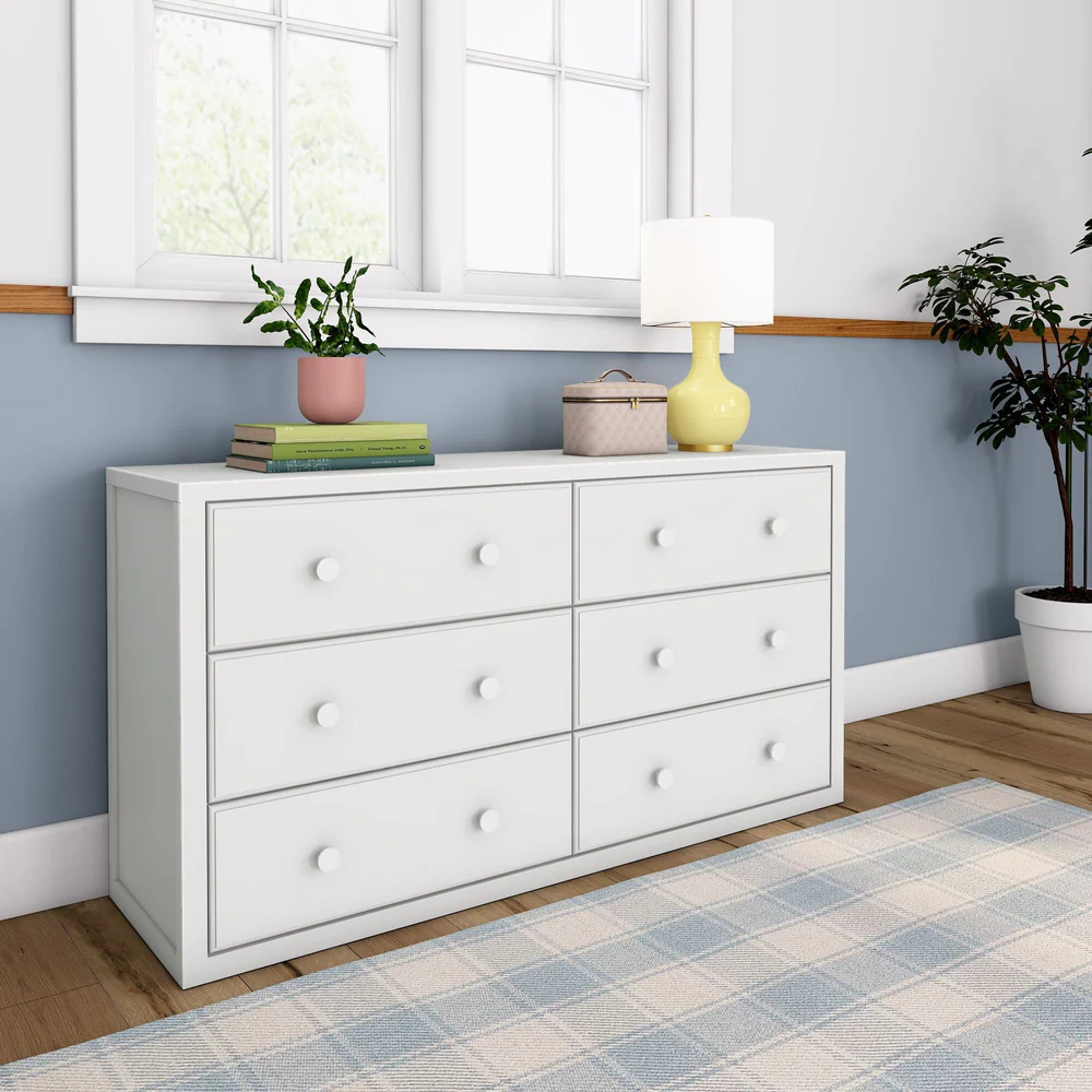 Maxtrix 6 Drawer Dresser in White - side angle view in a bedroom beside a window and potted plant