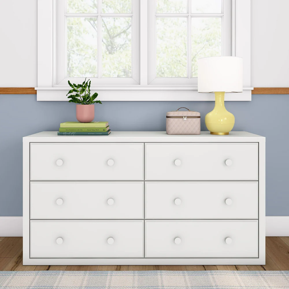 Maxtrix 6 Drawer Dresser in White - straight-on front view in a bedroom, showing all six drawers with round wooden knobs