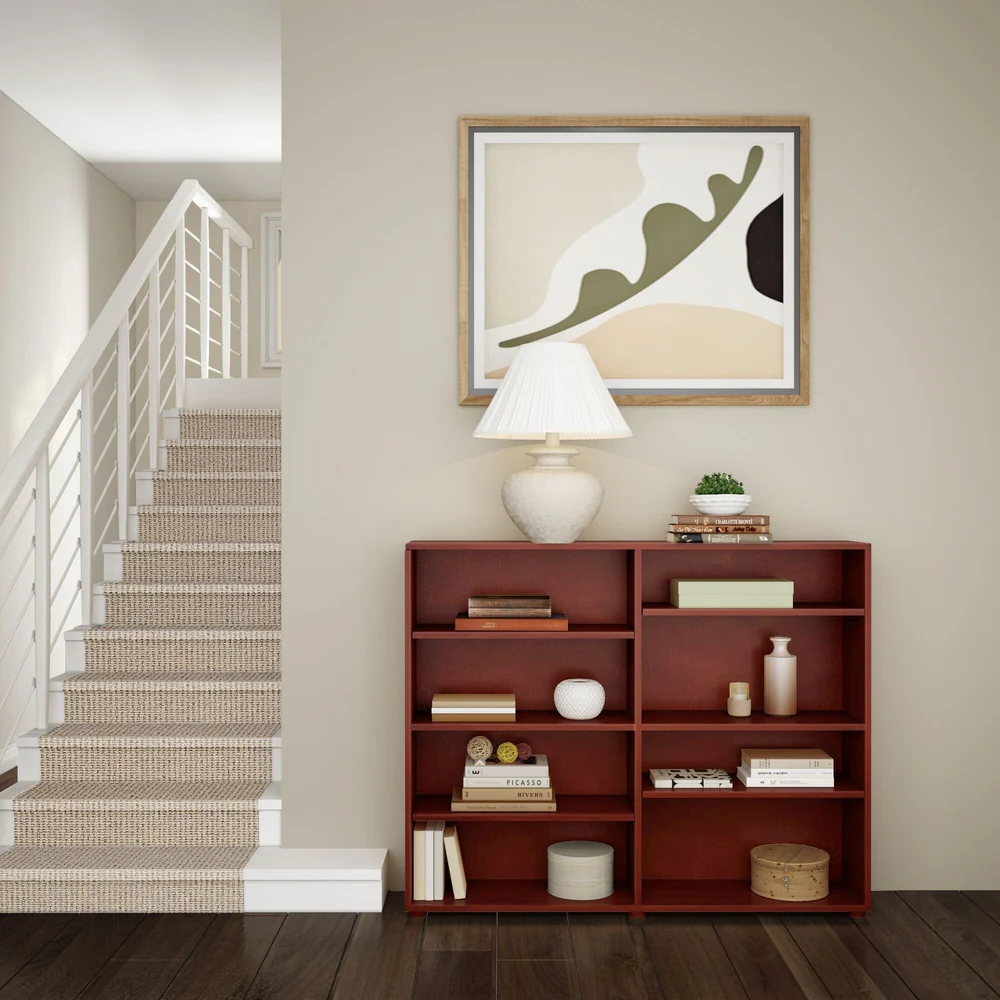 Maxtrix 8 Shelf Bookcase in Chestnut - styled in a hallway beside a staircase with books, vases and decor on its eight shelves