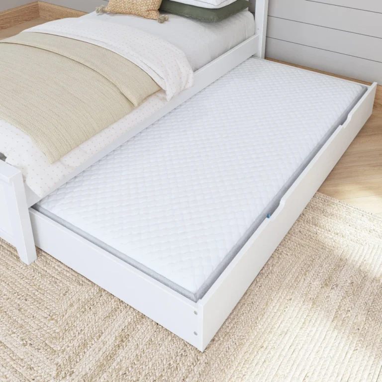 Maxtrix Trundle Bed With Slats White Trundle Open Maxtrix Trundle Bed with Slats in White - trundle pulled out from under a bed with a mattress inside, shown in a cozy bedroom on a woven rug