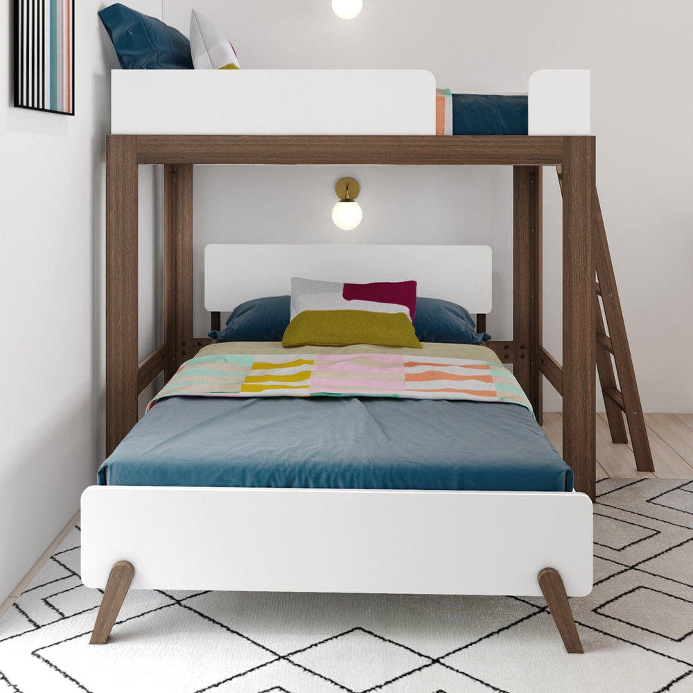 Mid-Century Modern Twin Over Full L-Shaped Bunk Bed in White/Walnut - front view of the lower full bed with white headboard and splayed legs beneath the guardrailed twin loft in a styled bedroom