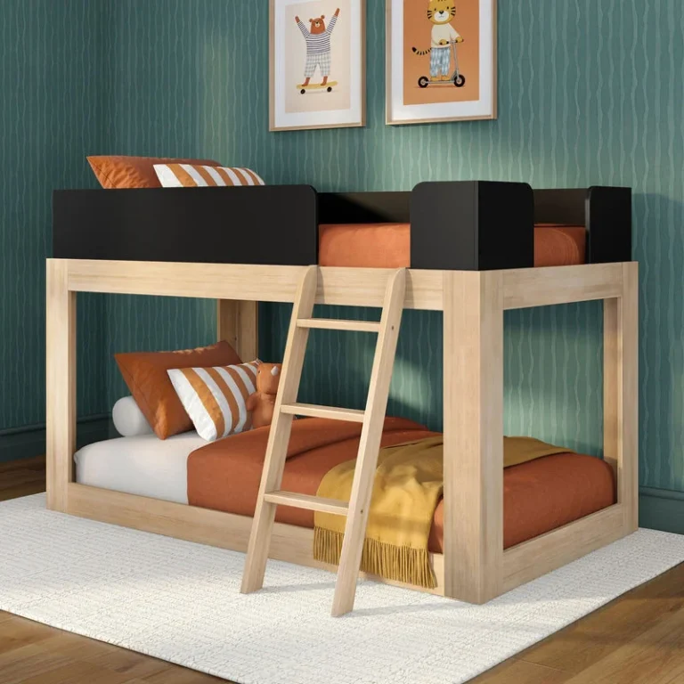 Mid-Century Modern Twin Over Twin Low Bunk Bed in Blonde/Black - angled view of the low bunk bed with black safety guardrails and slanted ladder in a styled kids room
