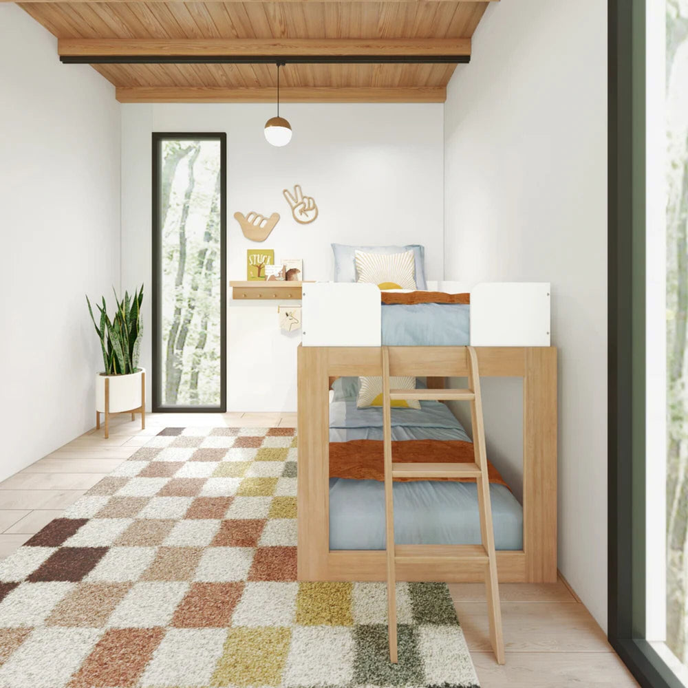 Mid-Century Modern Twin Over Twin Low Bunk Bed in White/Blonde - full room scene showing both made-up bunks with white guardrails and ladder on a checkered rug
