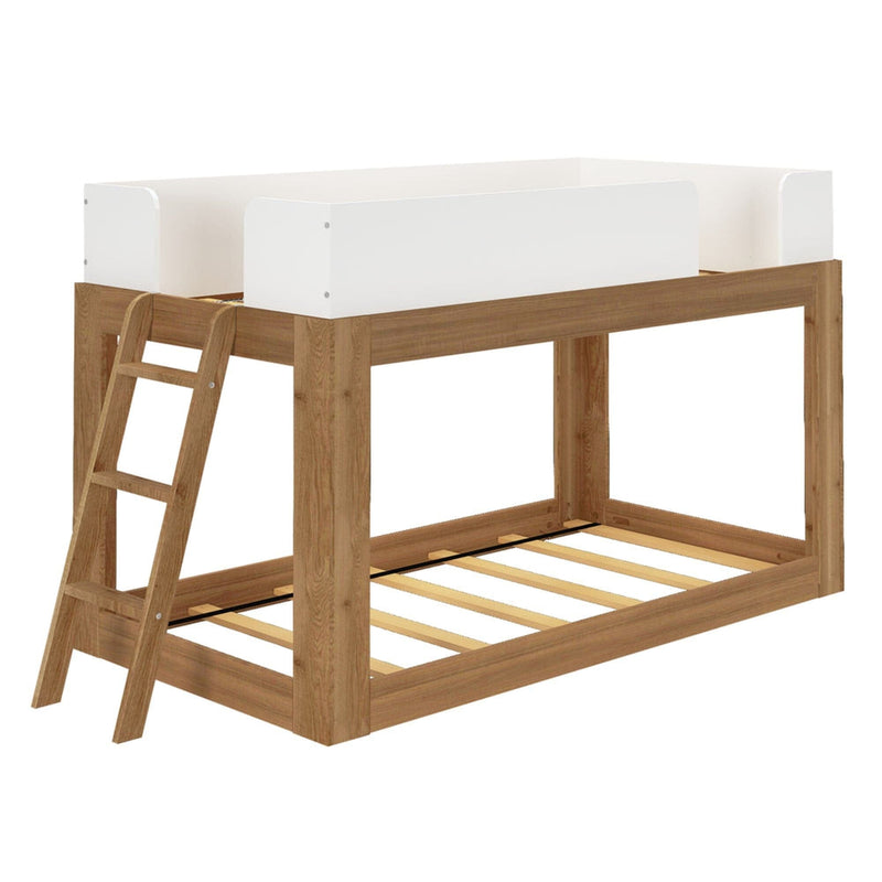 Mid-Century Modern Twin Over Twin Low Bunk Bed in White/Pecan - angle view on a plain background showing the wood slat foundations, white safety guardrails and hook-on angled ladder