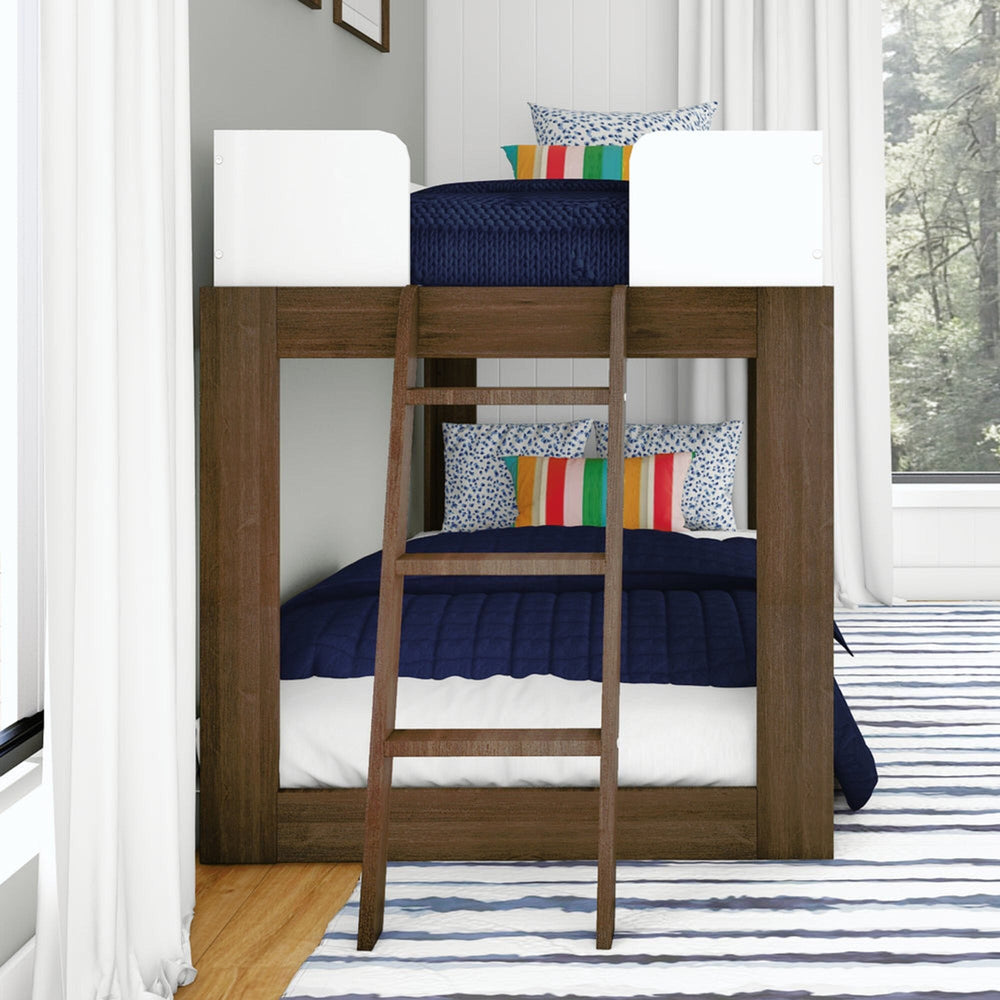 Mid-Century Modern Twin Over Twin Low Bunk Bed in White/Walnut - end view showing the angled climbing ladder and both bunks made up with navy bedding