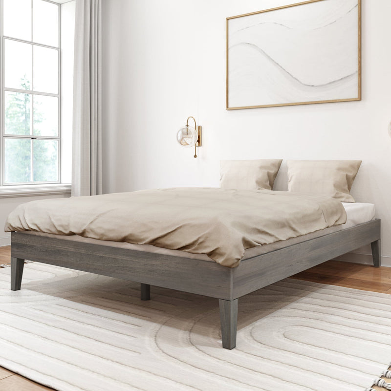 Queen Size Platform Bed in Driftwood - angled view of the low-profile bed made up with neutral bedding in a styled bedroom with a window and framed wall art.