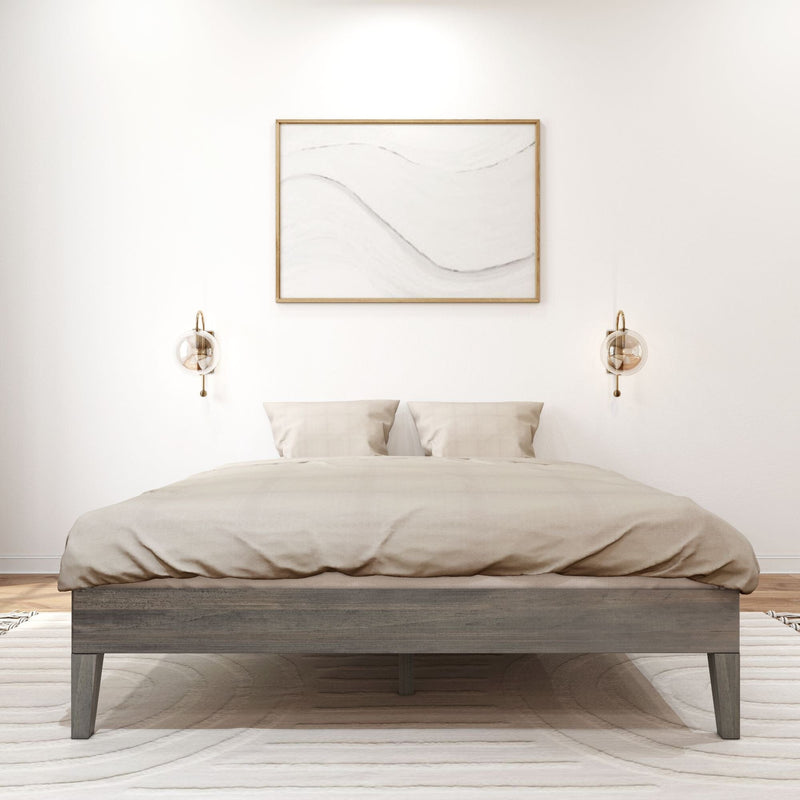 Queen Size Platform Bed Driftwood Front View Queen Size Platform Bed in Driftwood - front view of the foot of the made-up bed flanked by wall sconces and framed art in a bright bedroom.