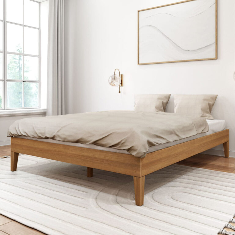 Queen Size Platform Bed Pecan Room Scene Queen Size Platform Bed in Pecan - styled with bedding in a bright bedroom with a window, wall sconce, and framed art, viewed at an angle