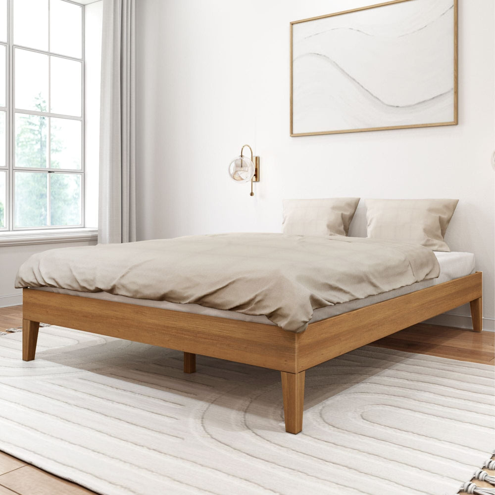 Queen Size Platform Bed in Pecan - styled with bedding in a bright bedroom with a window, wall sconce, and framed art, viewed at an angle